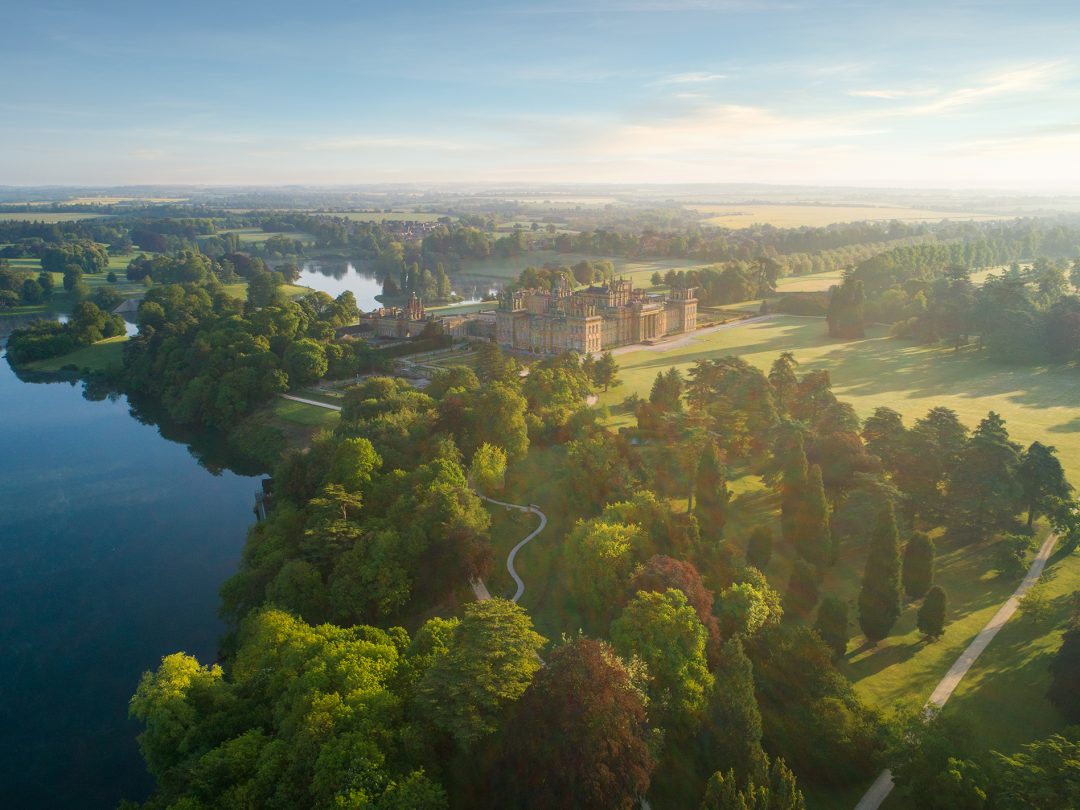 The lake and parkland at Blenheim in early morning light, with the Palace beyond