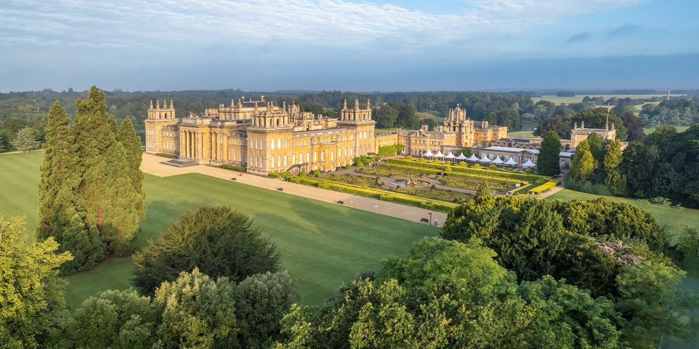 Blenheim Palace from the air on a clear day, with lawns and the formal gardens alongside