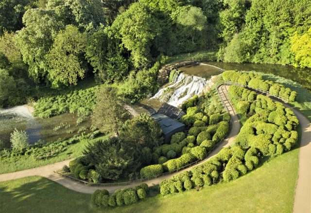The Grand Cascade falling from the lake, with a winding path and clipped shrubs above it