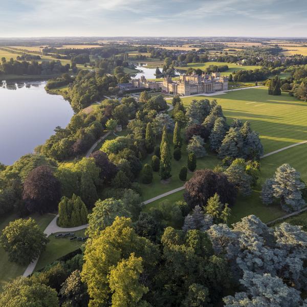 Aerial view of Blenheim Palace across the lake and parkland