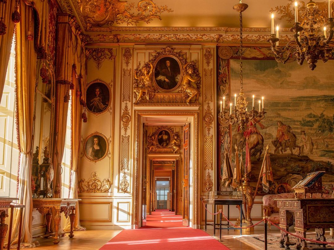 A State Room looking through the enfilade of gilded doorways, with a red carpet runner