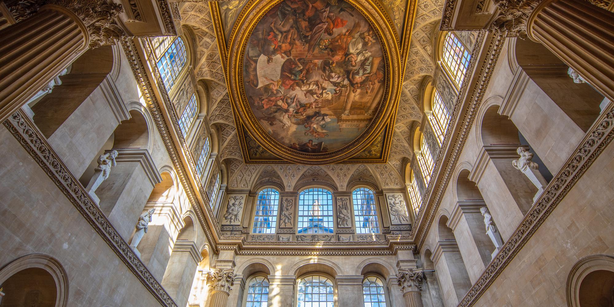 Sir James Thornhill's painted ceiling in the Great Hall, seen from below between the Corinthian columns