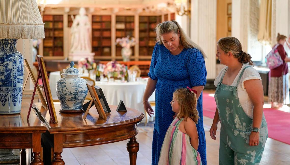 Young family looking at items in the Palace
