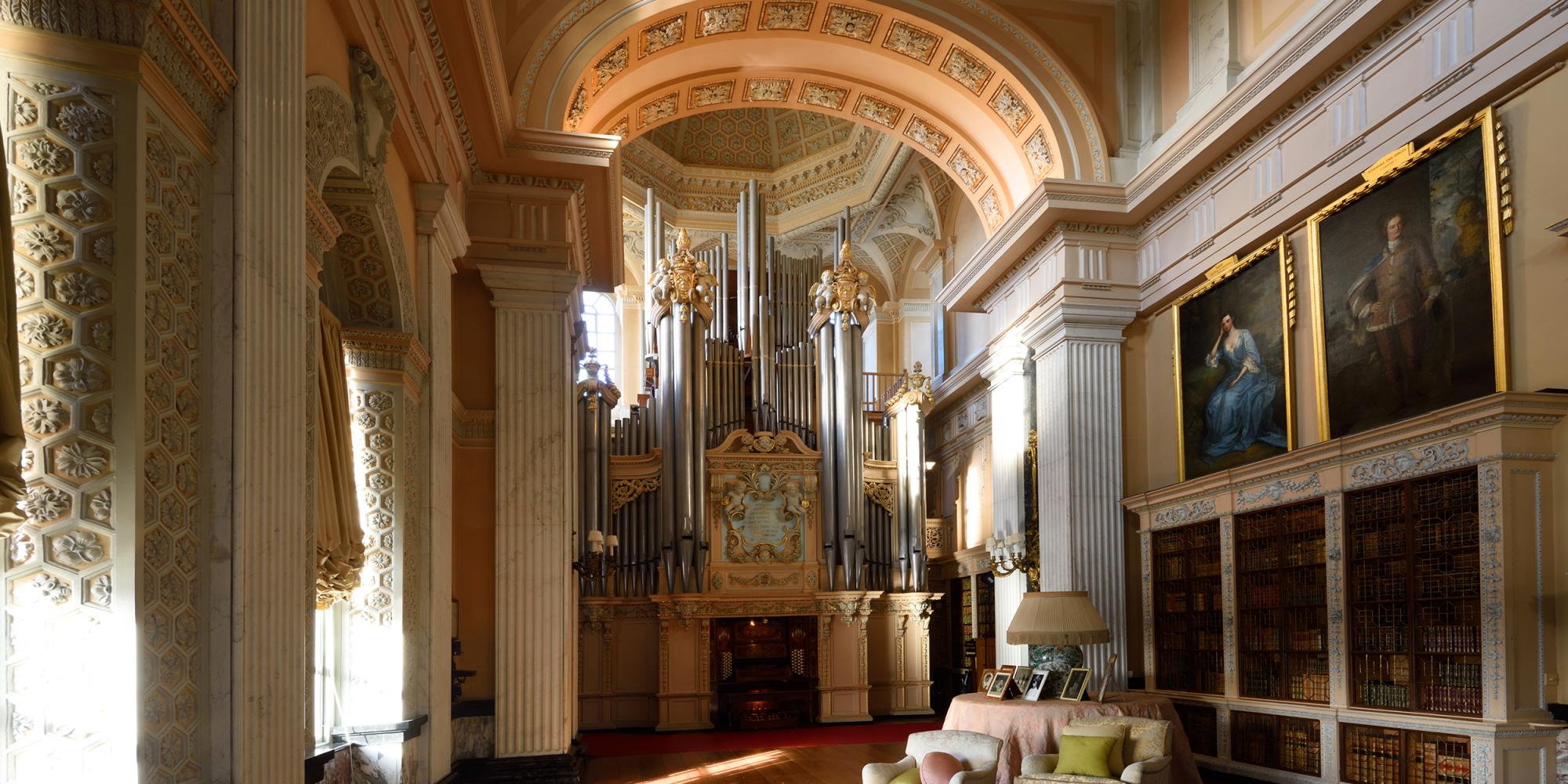 The Willis organ at the end of the Long Library, with bookcases and family portraits alongside
