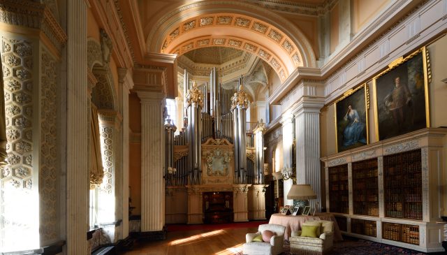 The Willis organ at the end of the Long Library, with bookcases and family portraits alongside