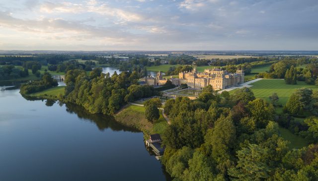 Blenheim Palace seen from across the lake, with parkland stretching to the horizon