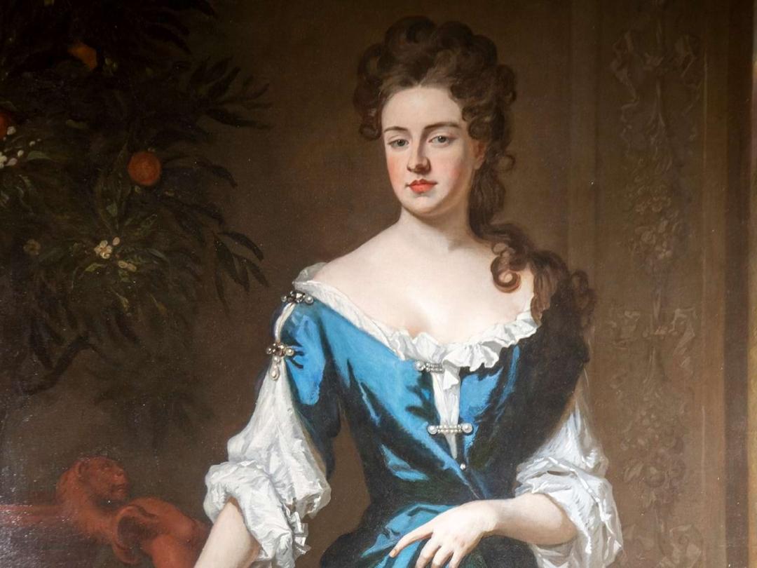 A portrait of Sarah, 1st Duchess of Marlborough, in a blue gown beside an orange tree in fruit