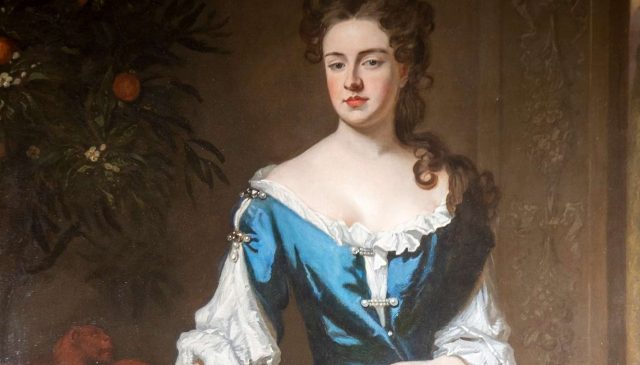 A portrait of Sarah, 1st Duchess of Marlborough, in a blue gown beside an orange tree in fruit