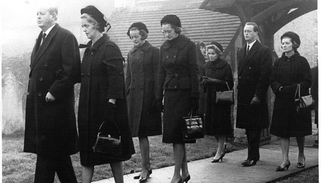 Black and white photograph of mourners passing a churchyard at Sir Winston Churchill's funeral